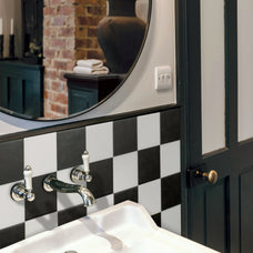 White and black checkerboard peel and stick backsplash tile by Smart Tiles in a rustic bathroom with exposed brick