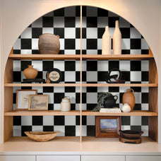 White and black checkerboard sticker backsplash tile by Smart Tiles inside a cabinet with vintage accessories.
